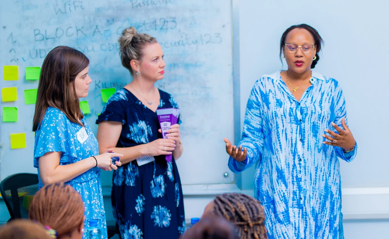 Facilitator speaking to a group in a workshop setting